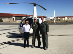pilots in front of helicopter